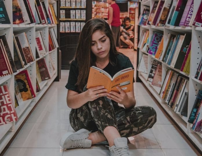 Girl reading a book overcome sadness