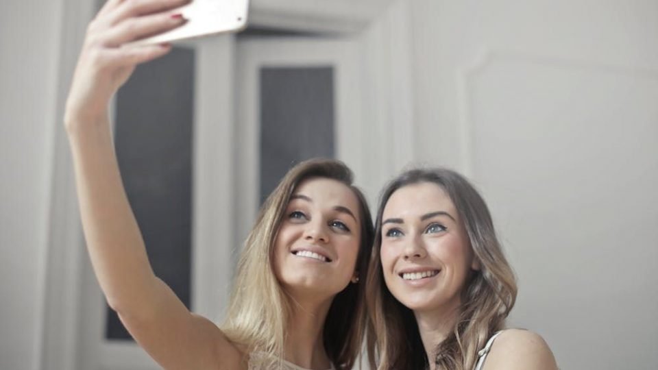 Two Womens Taking Selfies Bad Habits That Can Be Good