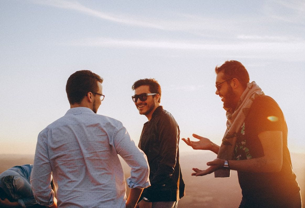 Three Friends Laughing While Standing.