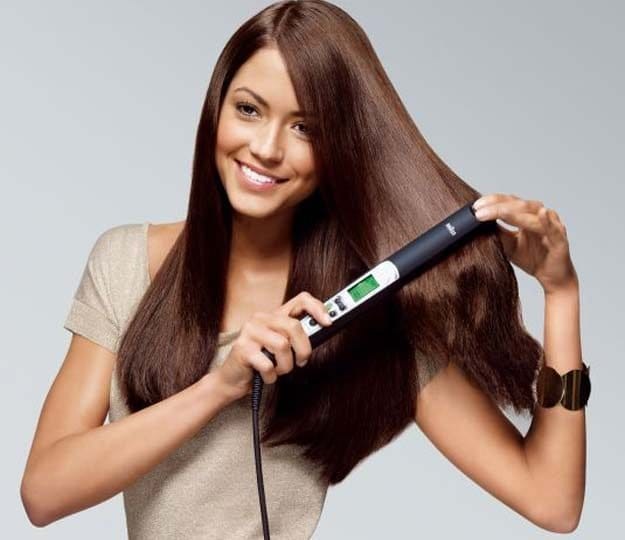 Woman Straightening Her Hair Get Ready For A Date Night