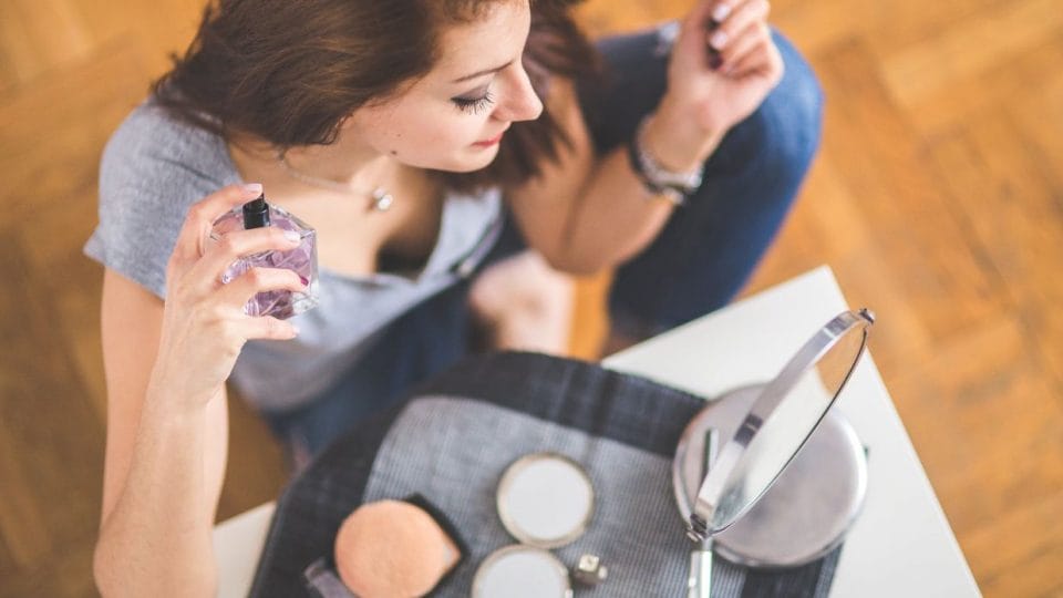 Woman Sprinkling A Perfume Get Ready For A Date Night
