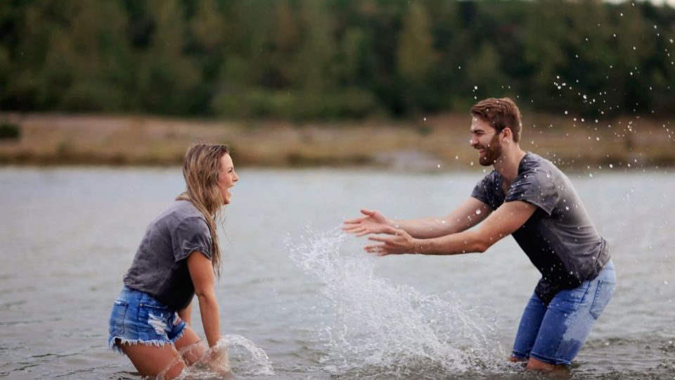 Man And Woman Playing On Body Of Water