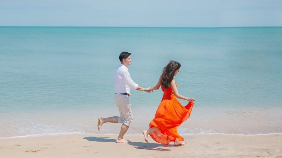 Couple Enjoying On A Beach