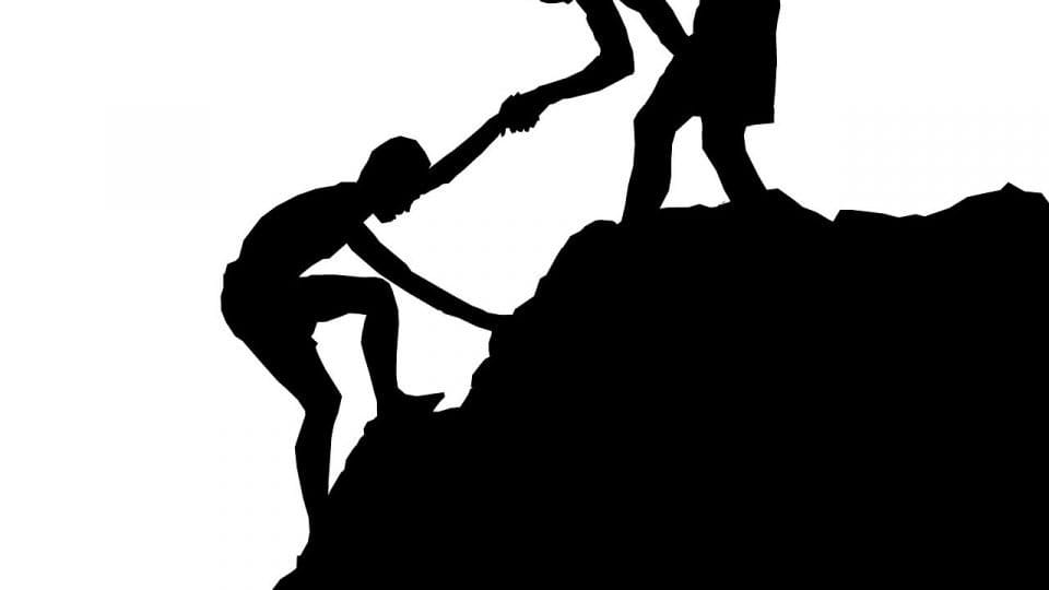 A Boy Helping His Friend To Climb The Mountain - the most important thing in life