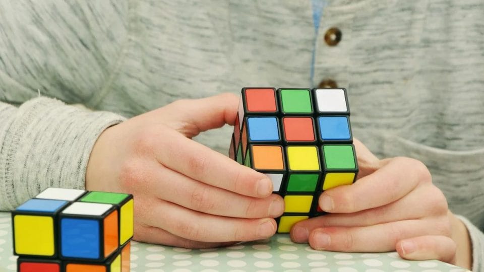 A Man Playing With A Cube Be More Confident