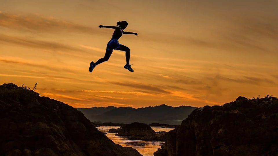 Woman Jumping From A Short Mountain - the most important thing in life