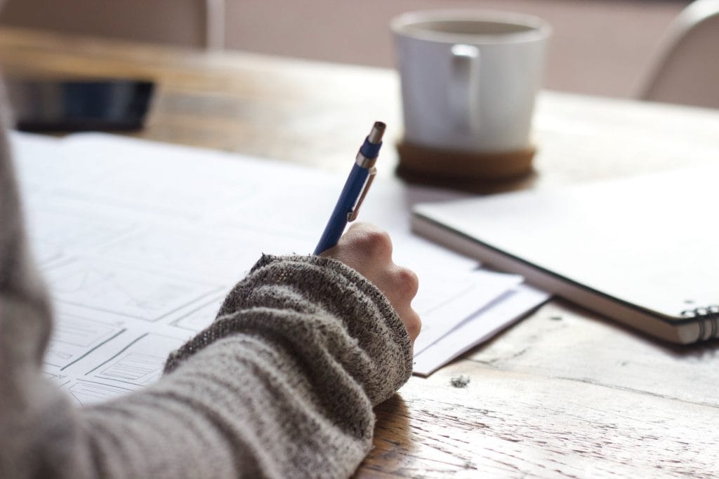 Writing on notebook - trending commerce presentation topics