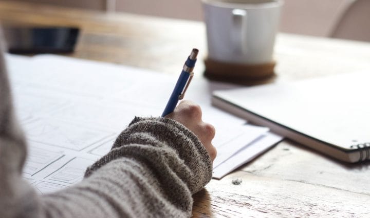 Writing on notebook - Trending Commerce Presentation Topics