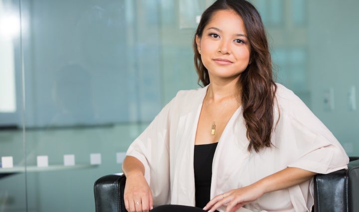 A Businesswoman Sitting In An Office Chair, Smiling