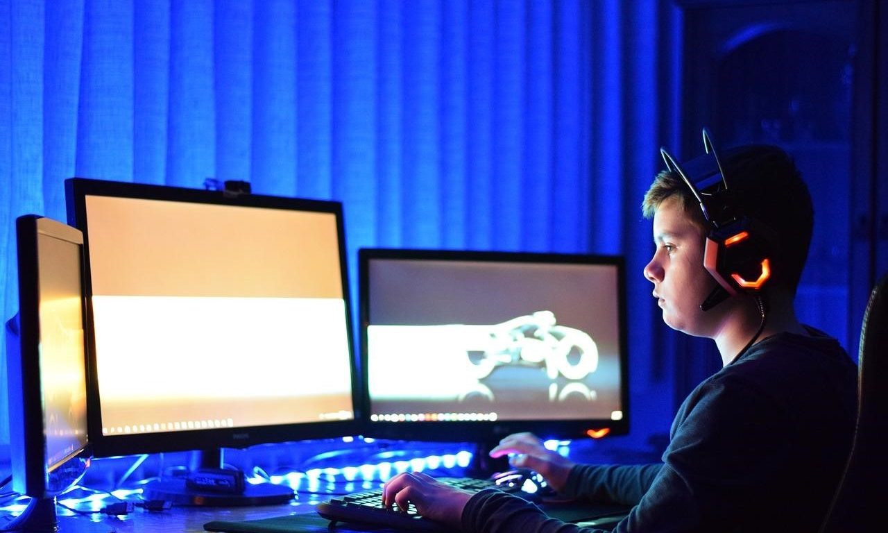 A Boy Playing A Game On A Gaming PC