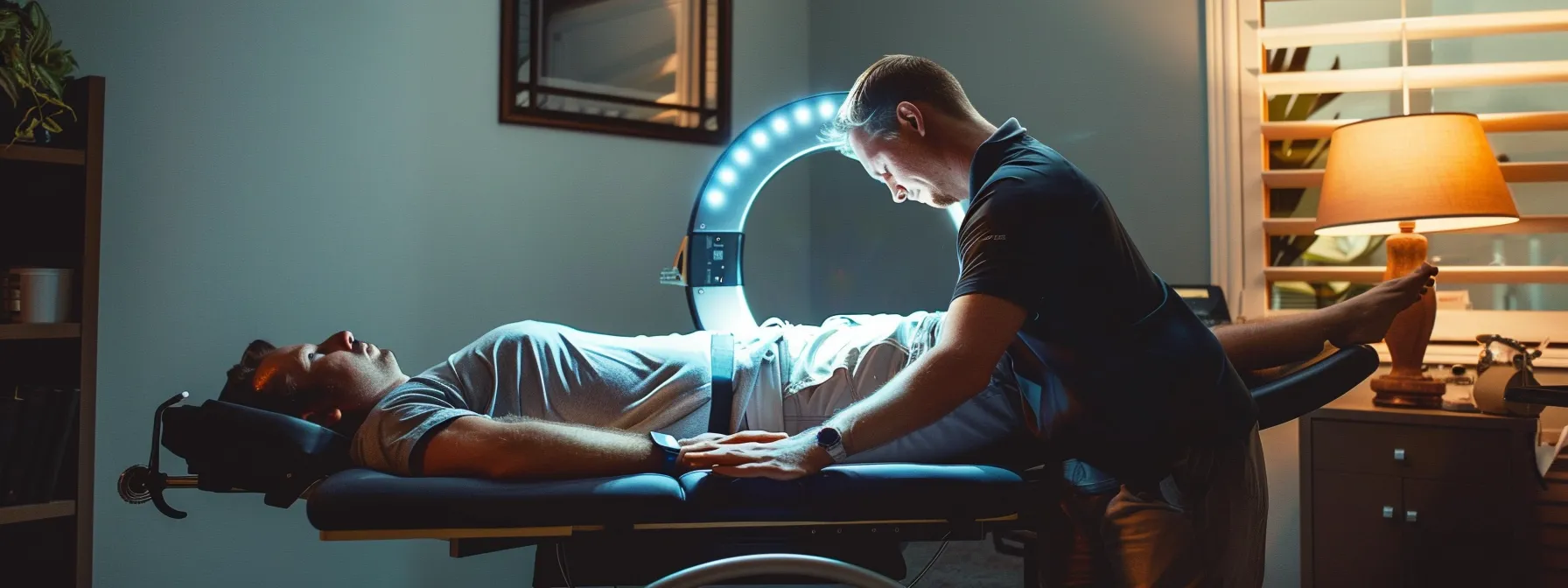 4b02497d 6ab1 4a85 9043 3d075df16cf5 A chiropractor performing a ring dinger therapy on a patient lying on a specialized traction table.