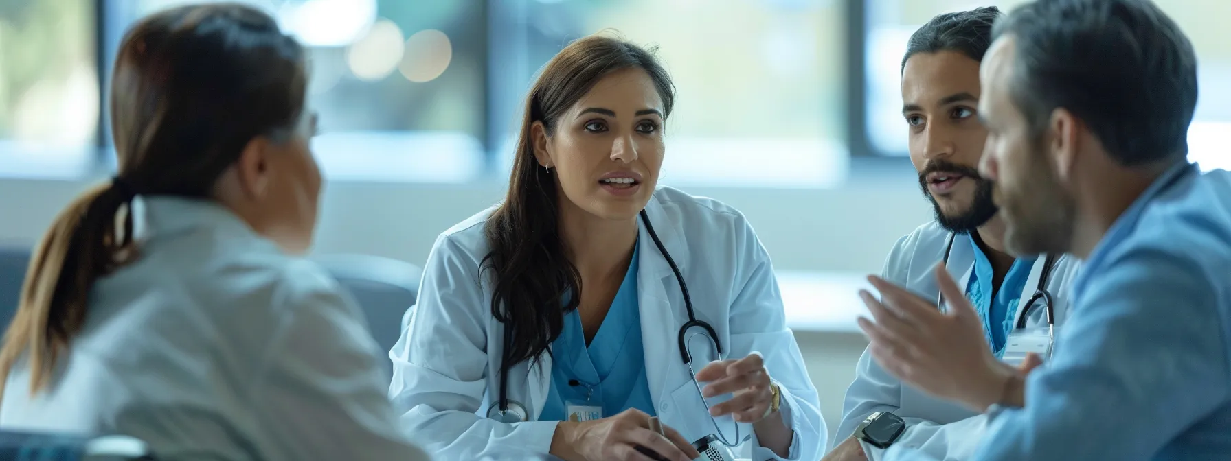 F0d62eda f798 4020 8590 fa1884c12225 Group of professionals discussing positive outcomes of ring dinger therapy.